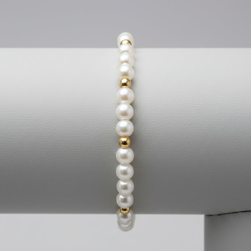 Miss Radiance pearl and gold-filled bead bracelet on a wooden display