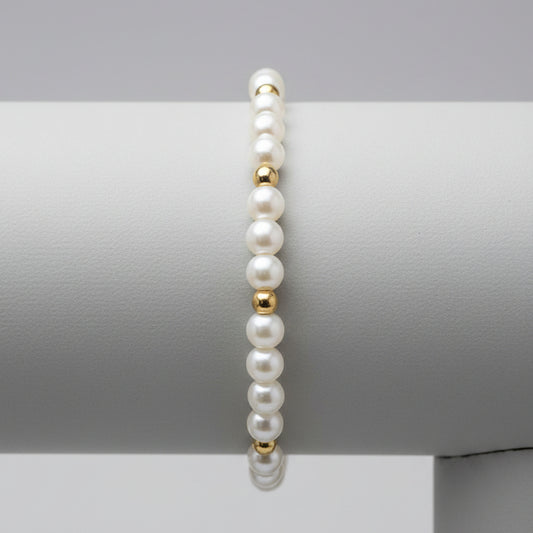 Miss Radiance pearl and gold-filled bead bracelet on a wooden display